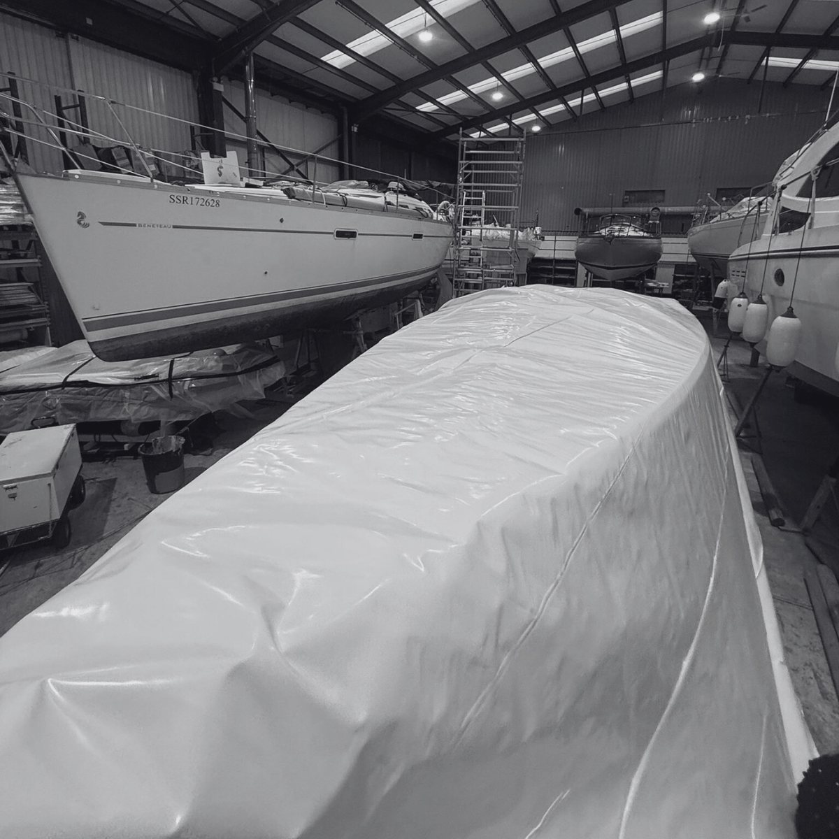 Boats stored ashore under shrink wrap covers