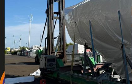 Shrink wrapped yacht lifted in a travel hoist ready to move
